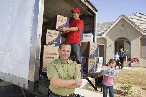 Removal van and movers preparing a local house move in Alperton