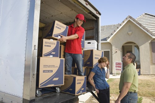 Professional removals team handling furniture in Alperton