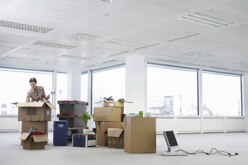 Family sorting items for household storage in Alperton